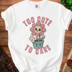 White t-shirt with skull flower graphic and text "TOO CUTE TO CARE".
