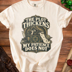 Cream t-shirt with "The Plot Thickens, My Patience Does Not" graphic and wizard.