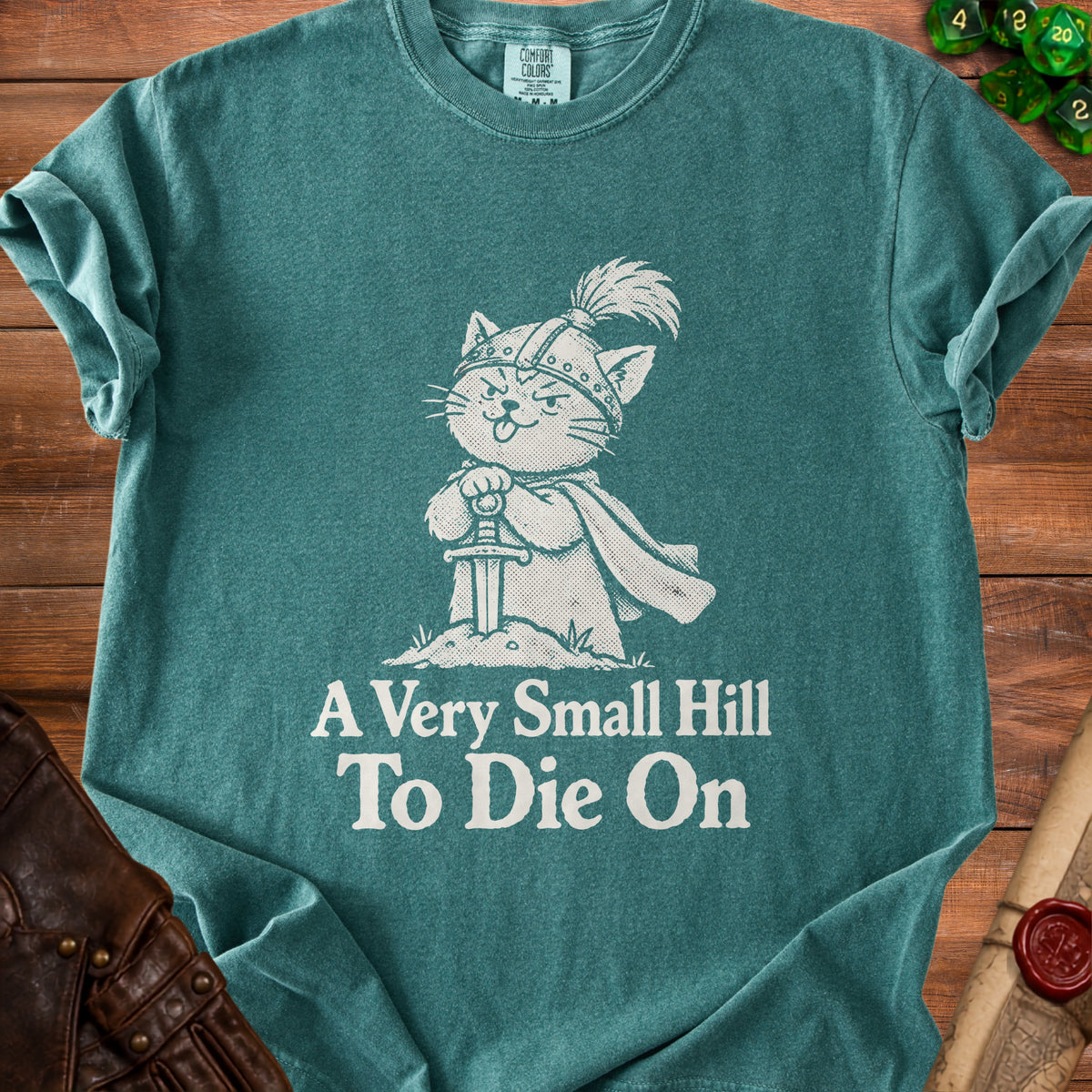 Green t-shirt with a knight cat design and text "A Very Small Hill To Die On".