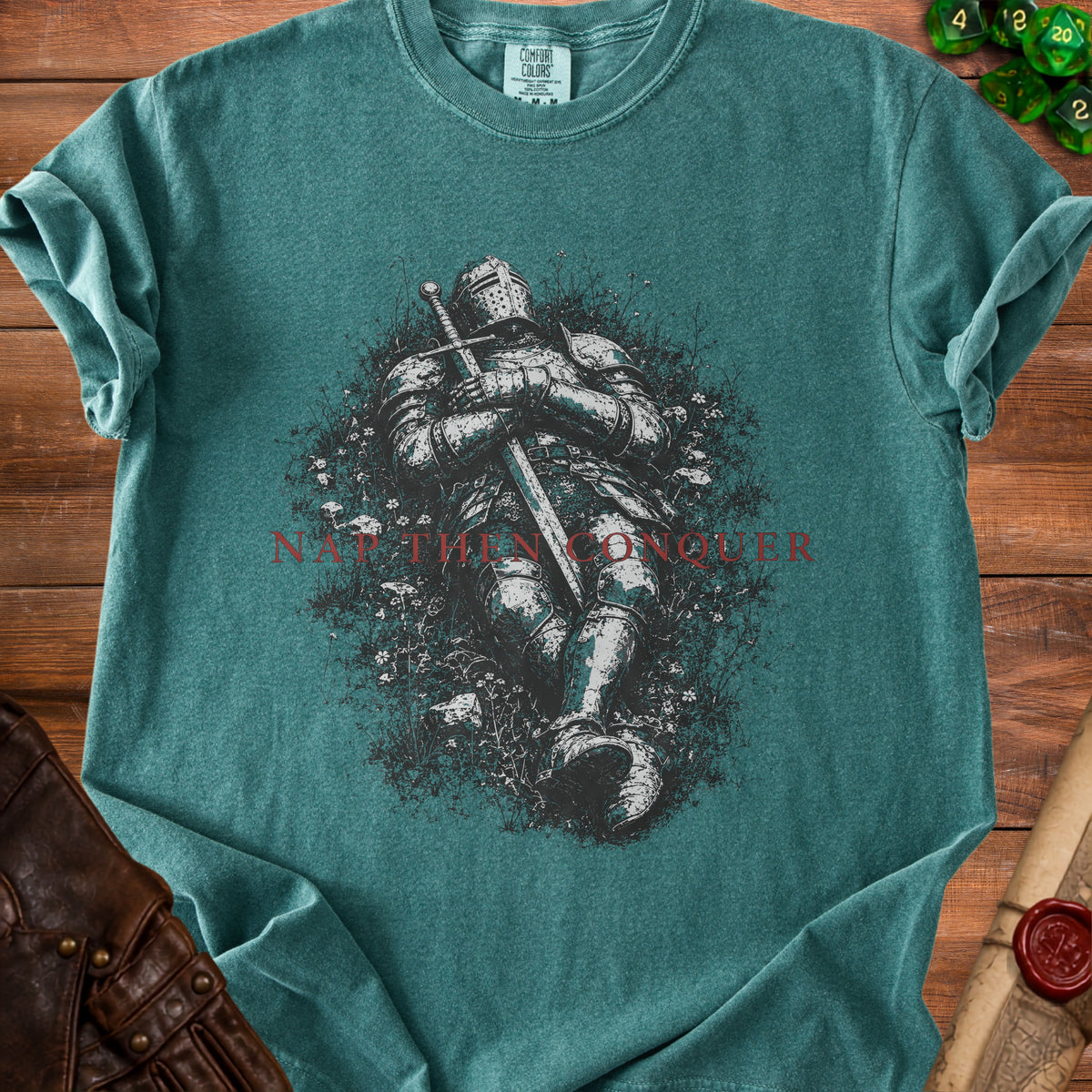 Teal t-shirt with knight artwork and "NOT THEN CONQUER" text.