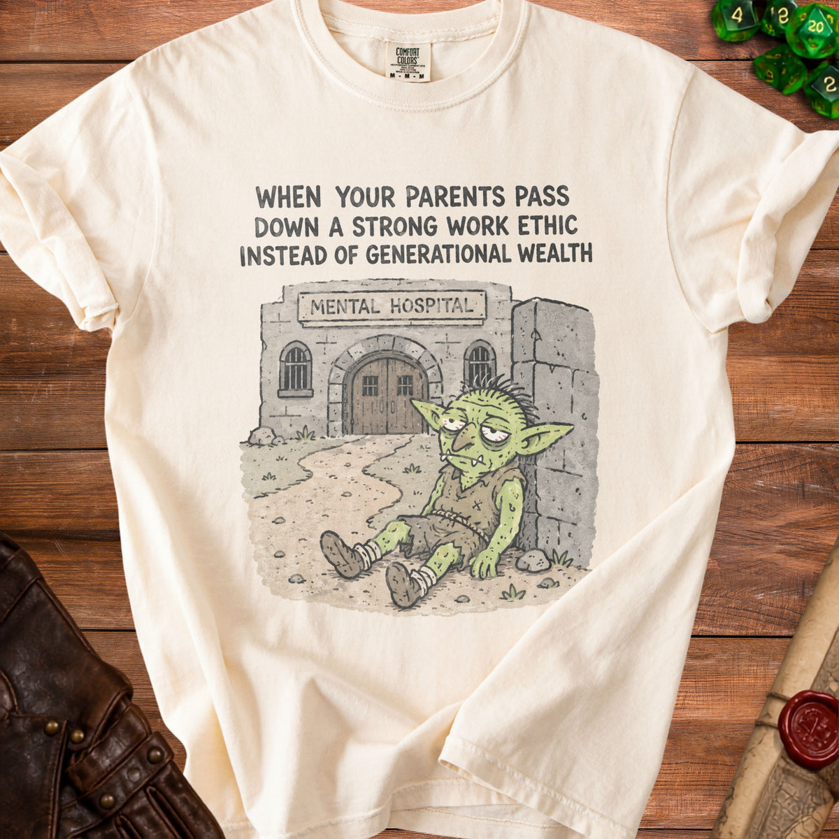 Cream t-shirt with a goblin leaning against a mental hospital building.