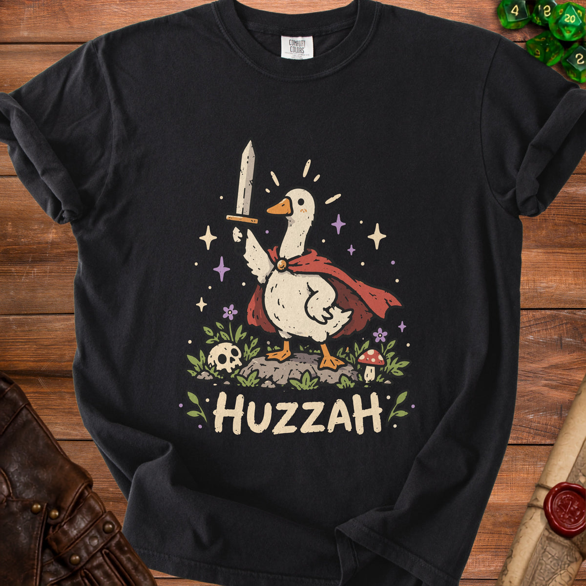 Black t-shirt with a cartoon goose holding a sword and the word "HUZZAH".