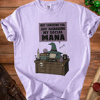 Light purple t-shirt with graphic of gnome, books, potion, and "Social Mana" text.
