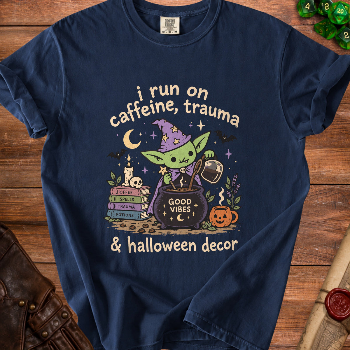 Green creature in wizard hat brews coffee with text "i run on caffeine, trauma & halloween decor".
