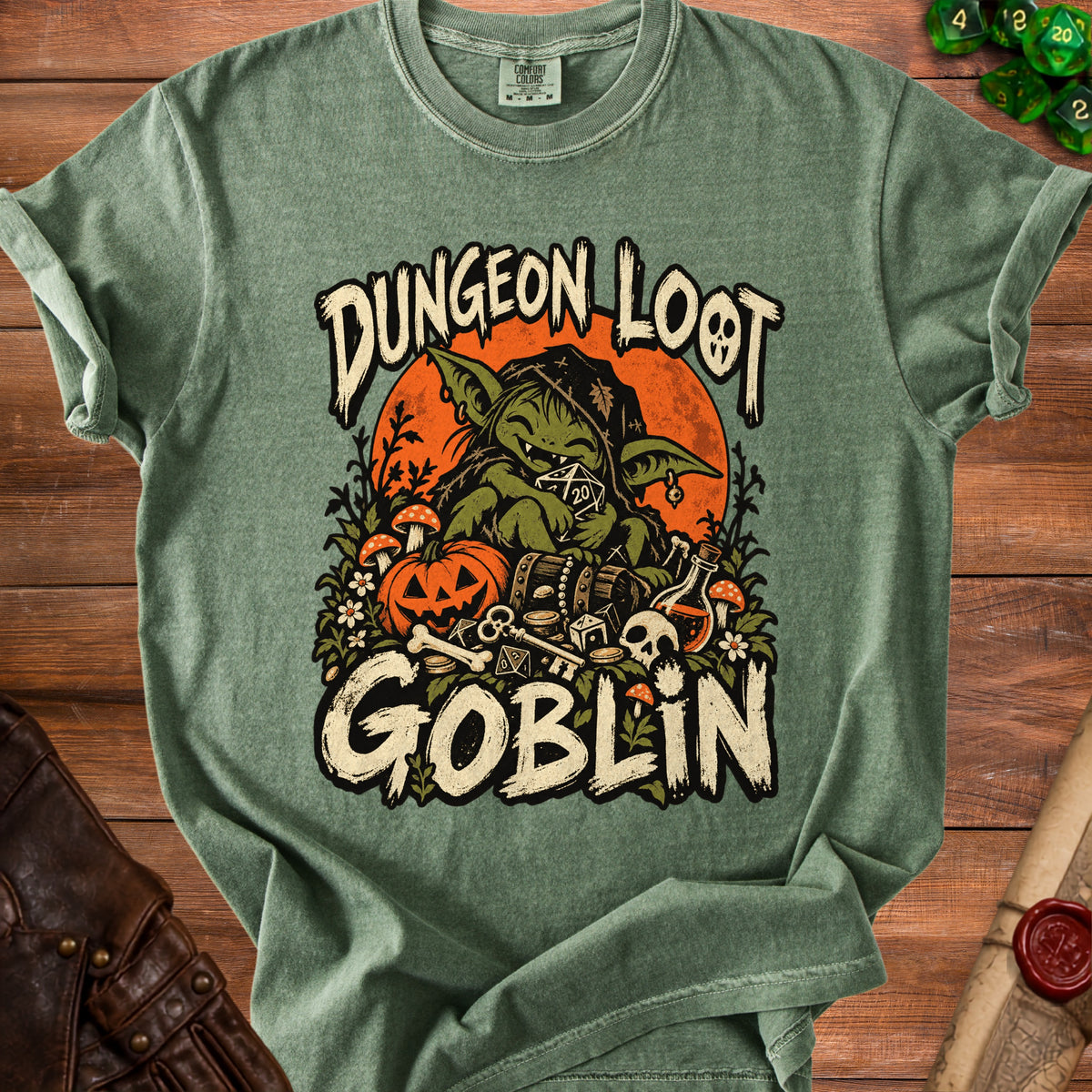 Green t-shirt with goblin, pumpkin, and treasure chest graphic; text reads "Dungeon Loot Goblin".