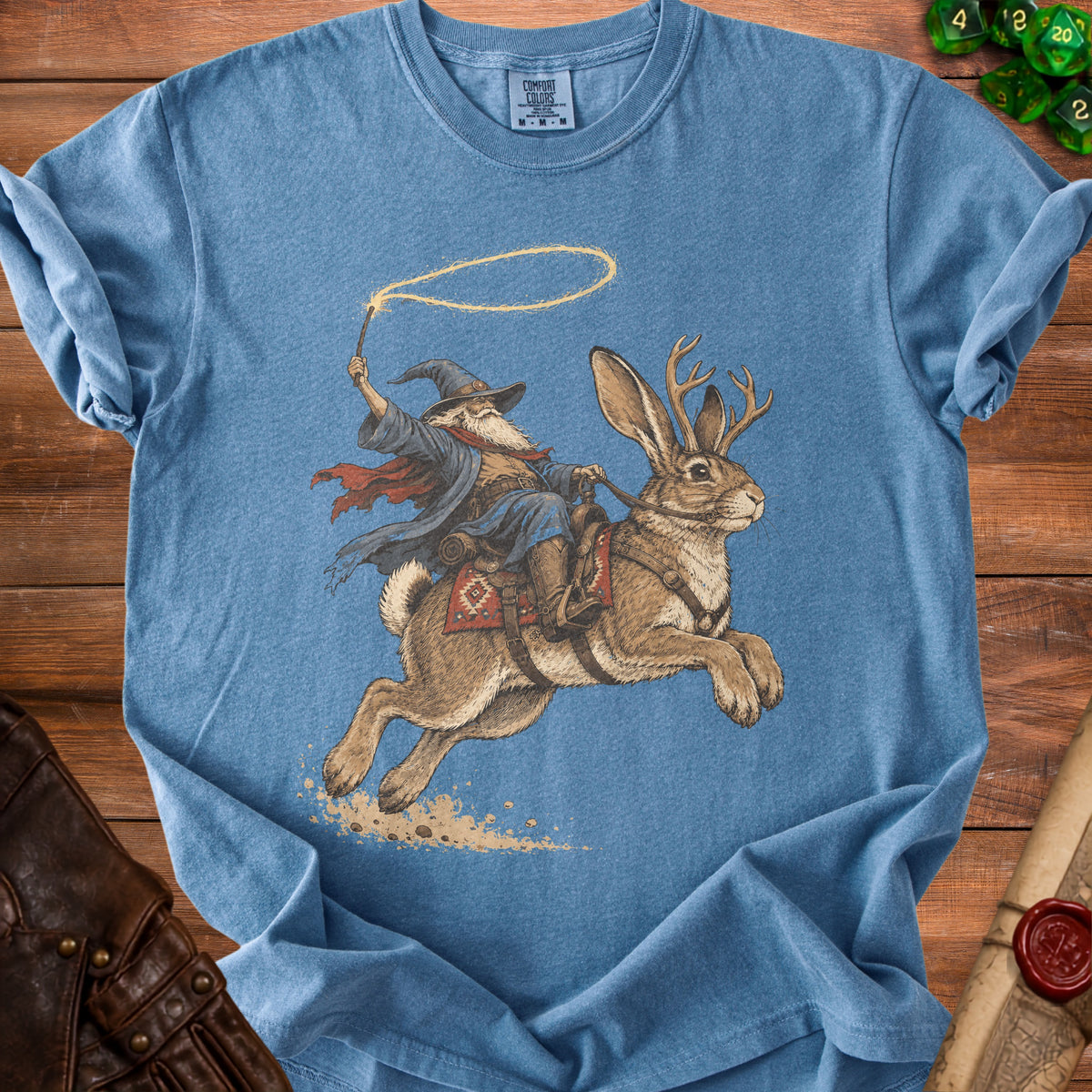 Wizard riding a jackalope with a lasso on a blue t-shirt.