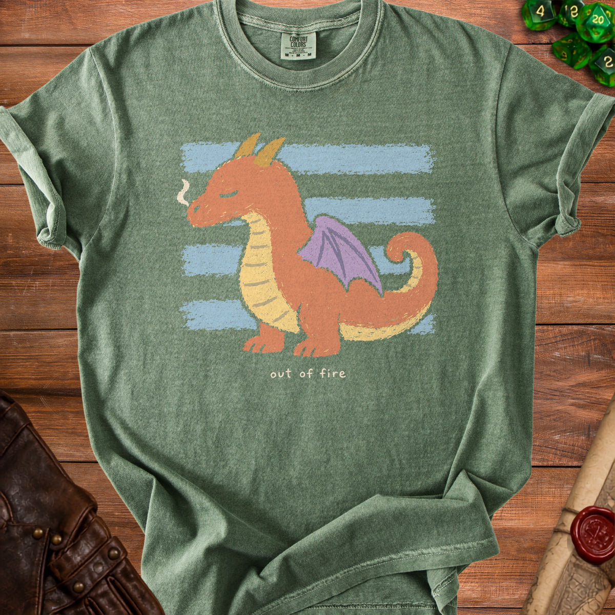 Green t-shirt with orange dragon graphic and "out of fire" text.