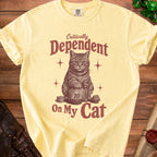 Yellow t-shirt with a cat graphic and text "Critically Dependent On My Cat".