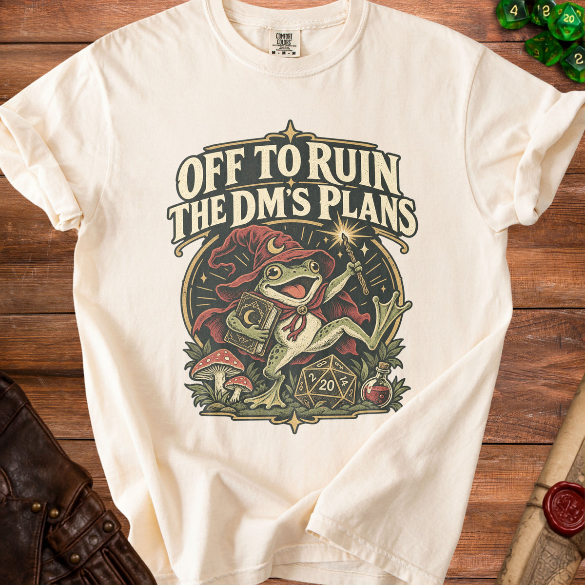 Cream t-shirt with "Off to Ruin The DM's Plans" text and a wizard frog.