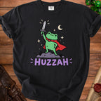 Black t-shirt with a cartoon frog in a red cape holding a sword, text "HUZZAH".