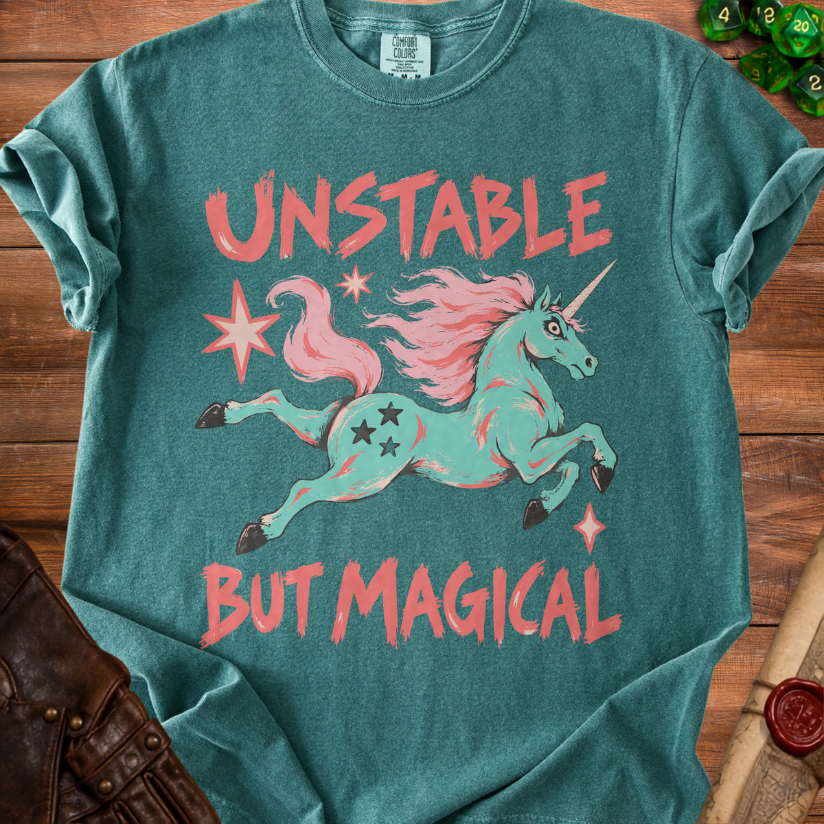 Teal t-shirt with "UNSTABLE BUT MAGICAL" and a teal unicorn graphic.