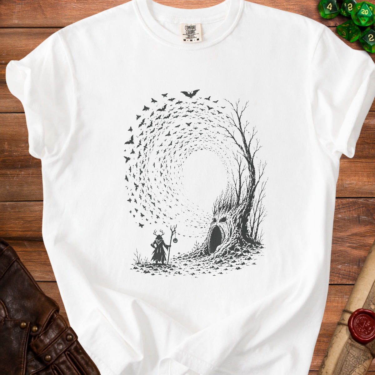White t-shirt with a black graphic of a cloaked figure, a hollow tree, and a swarm of bats.