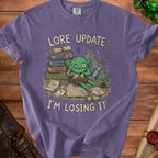 Purple t-shirt with goblin saying "Lore Update: I'm Losing It".