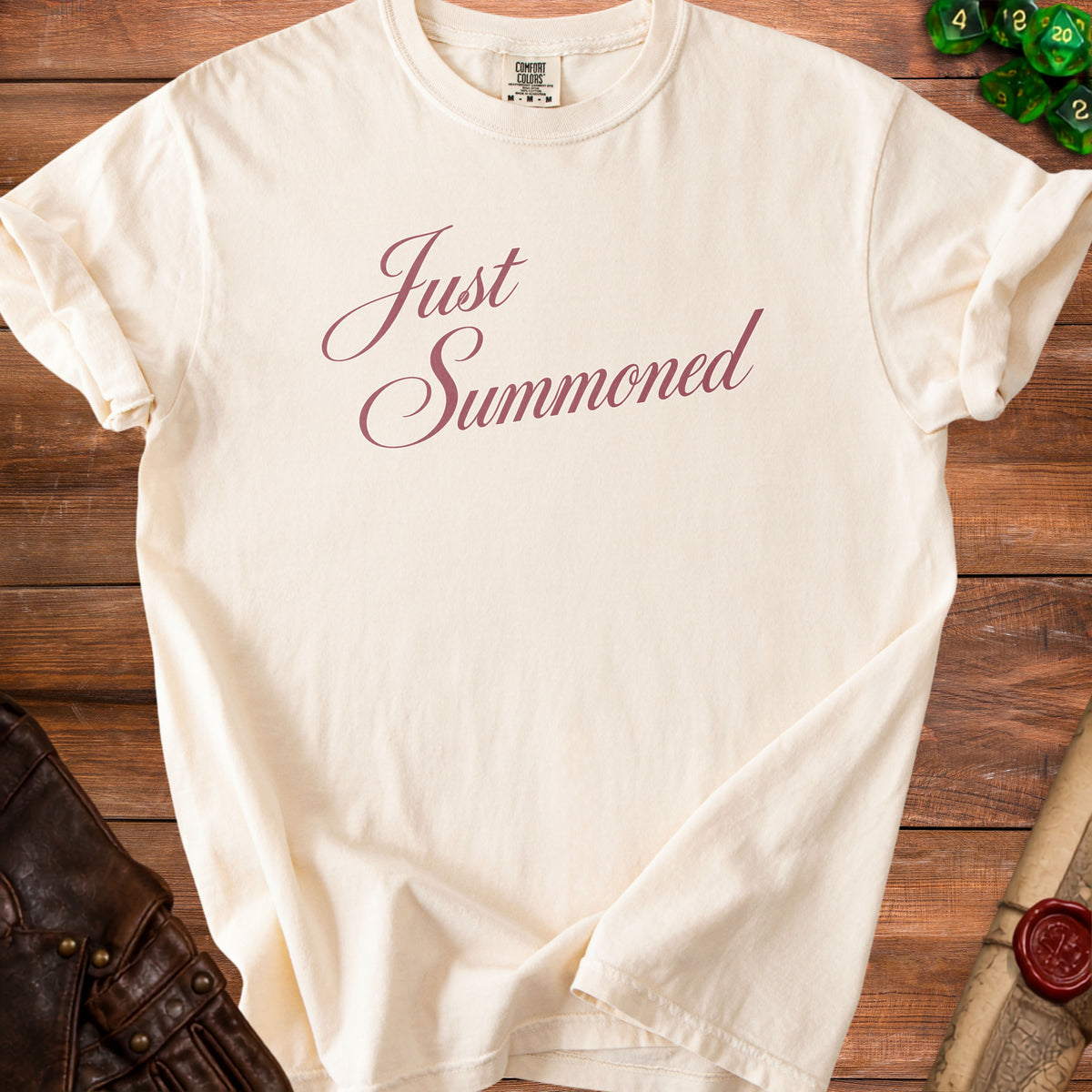 Cream t-shirt with "Just Summoned" text, dice, and leather gloves.
