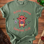 Green t-shirt with a cartoon demon holding a pentagram mug, saying "Please Summon Someone Else".