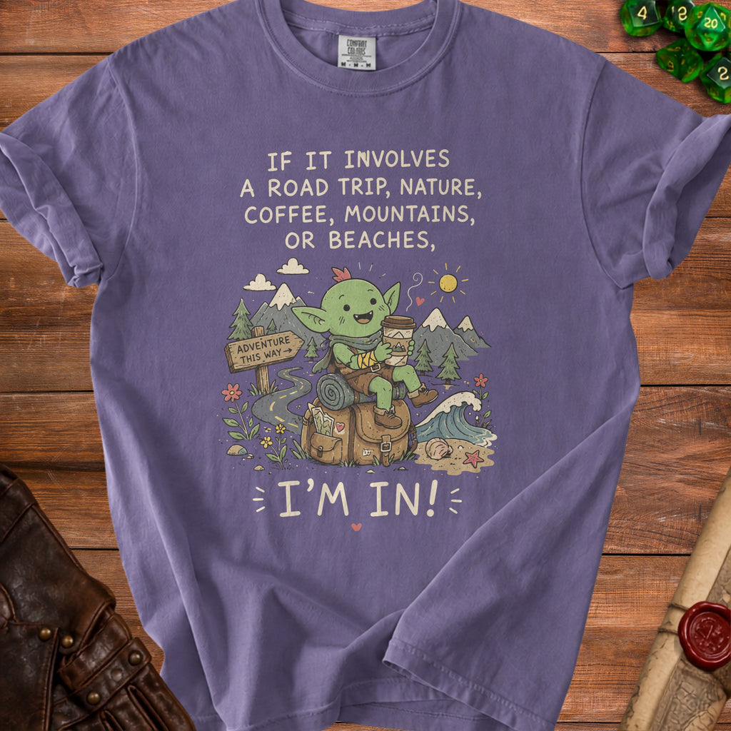 Purple t-shirt with text "IF IT INVOLVES A ROAD TRIP, NATURE, COFFEE, MOUNTAINS, OR BEACHES, I'M IN!".