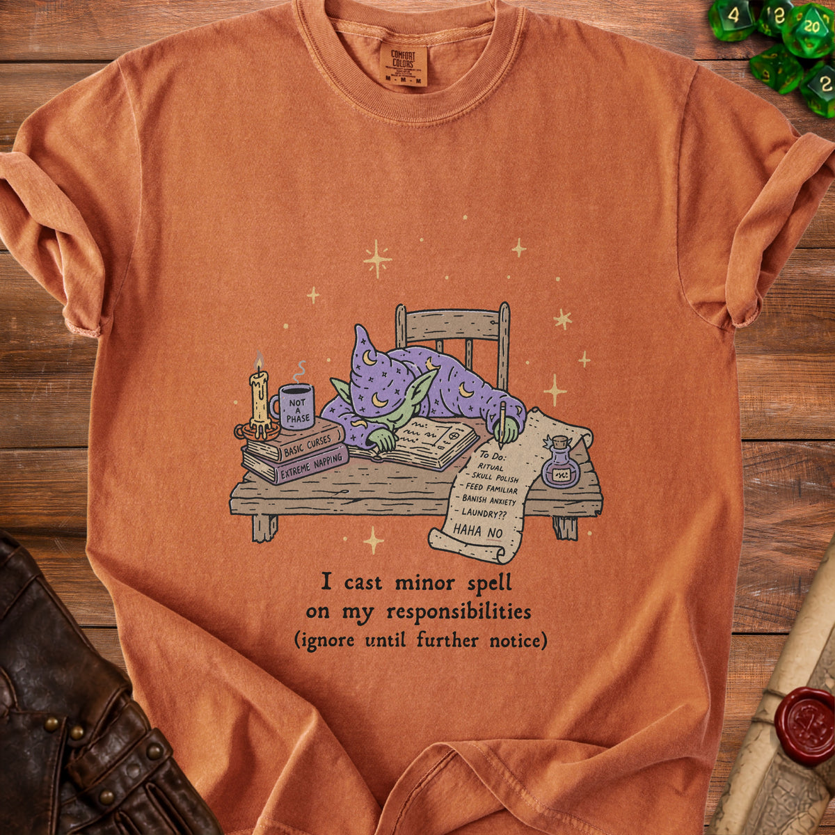 Orange t-shirt with wizard asleep at a desk, text reads "I cast minor spell on my responsibilities".