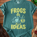 Dark green t-shirt featuring the text Frogs and bad ideas alongside a frog and a potion bottle.
