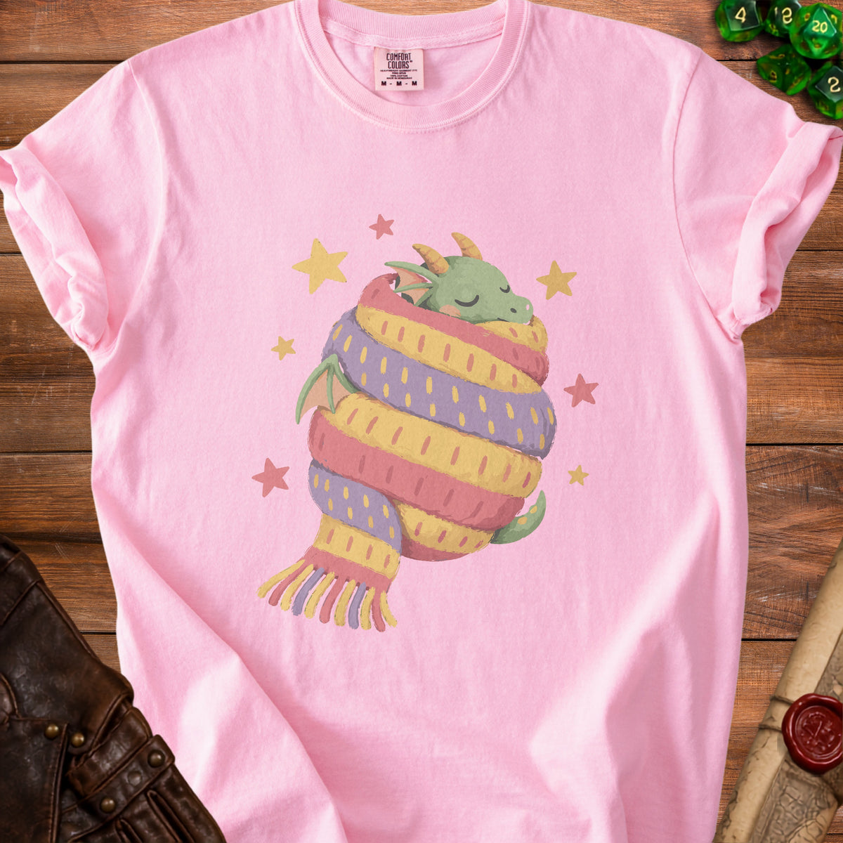 Pink t-shirt with sleeping dragon wrapped in a colorful scarf and stars.