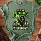A green t-shirt with a hooded necromancer graphic, a skeleton, scrolls, and text saying I BRING PEOPLE BACK JUST NOT TEXTS.