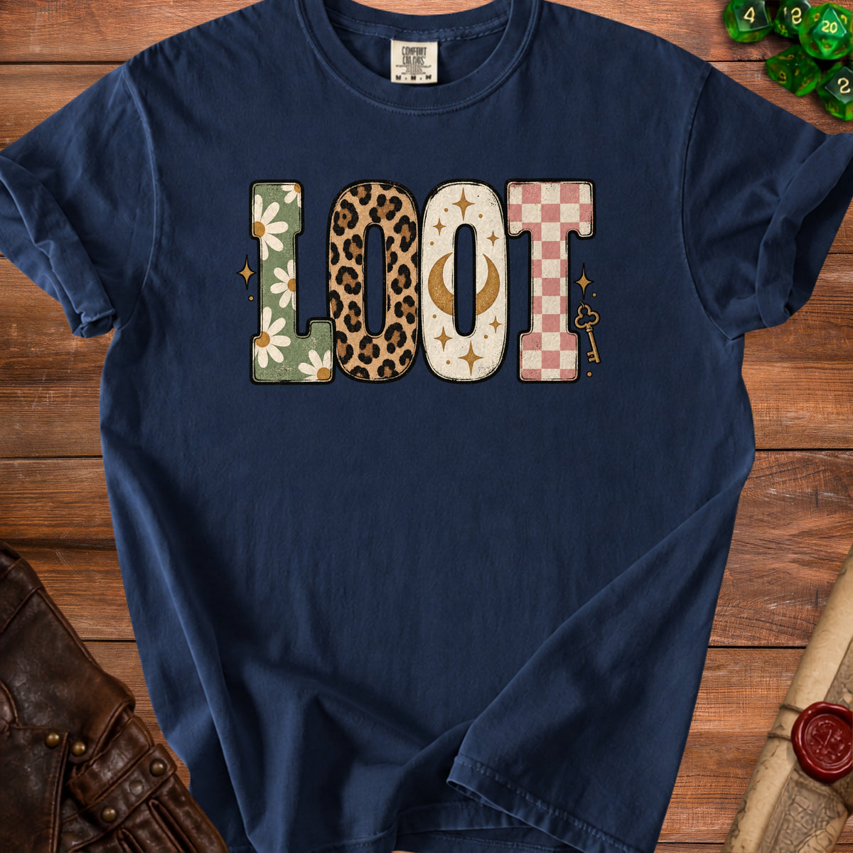 Navy t-shirt with "LOOT" text in floral, leopard, moon, and checkerboard patterns.