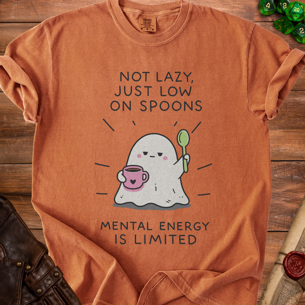 Orange t-shirt with a graphic of a ghost holding coffee and a spoon, reading "Not lazy, just low on spoons."