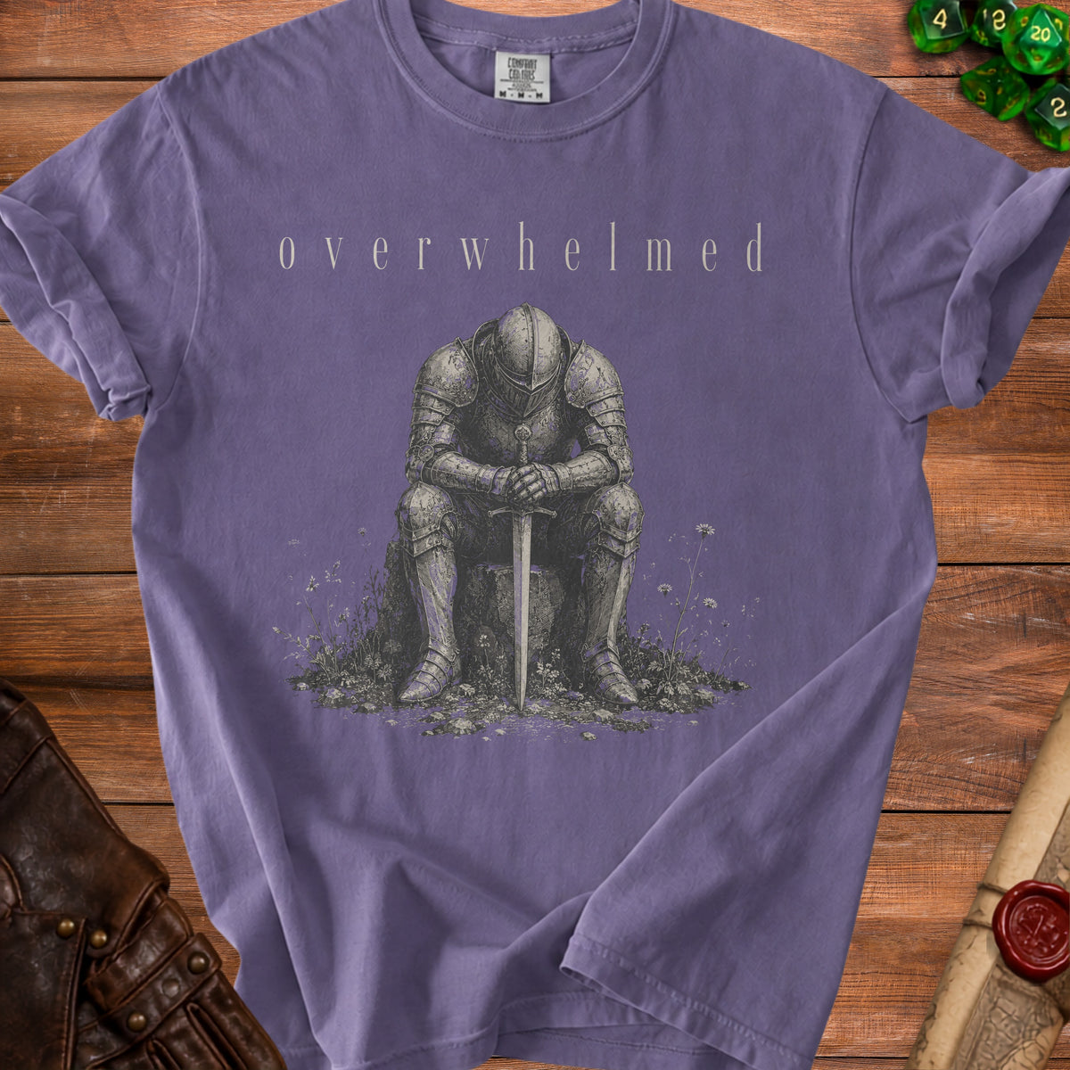Purple t-shirt with knight sitting and sword, text "overwhelmed"