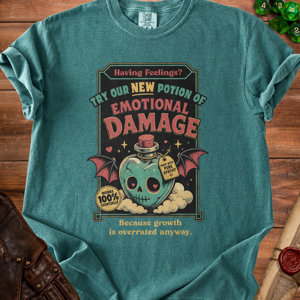 Teal t-shirt with "Emotional Damage" potion graphic and "Because growth is overrated anyway" text.