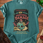 Teal t-shirt with "Emotional Damage" potion graphic and "Because growth is overrated anyway" text.