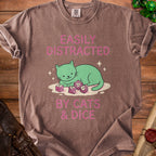 Brown t-shirt with pink text and graphics of a cat with dice.