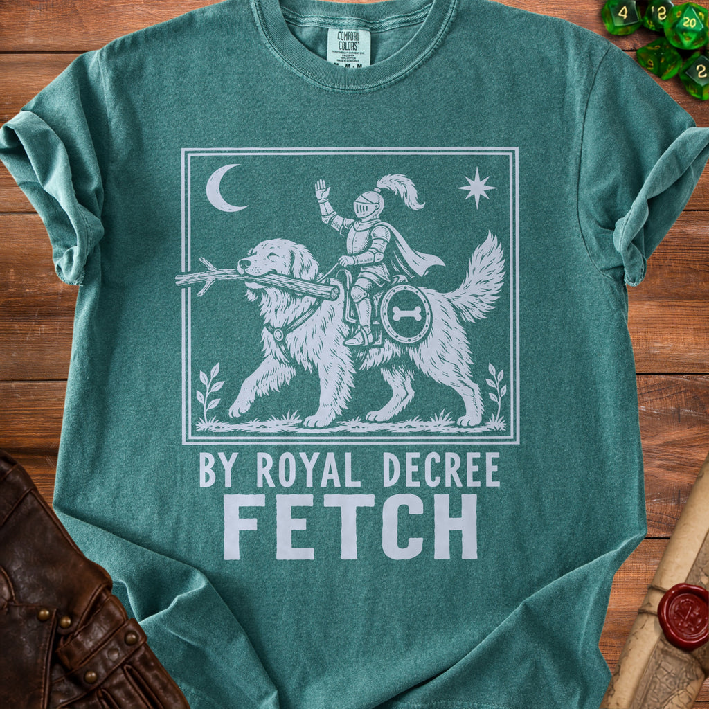 Green t-shirt with white graphic of dog carrying stick, knight on dog's back, "BY ROYAL DECREE FETCH".