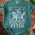Green t-shirt with white graphic of dog carrying stick, knight on dog's back, "BY ROYAL DECREE FETCH".