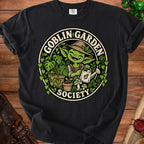 Goblin Garden Society design on a black t-shirt featuring a gardening goblin.