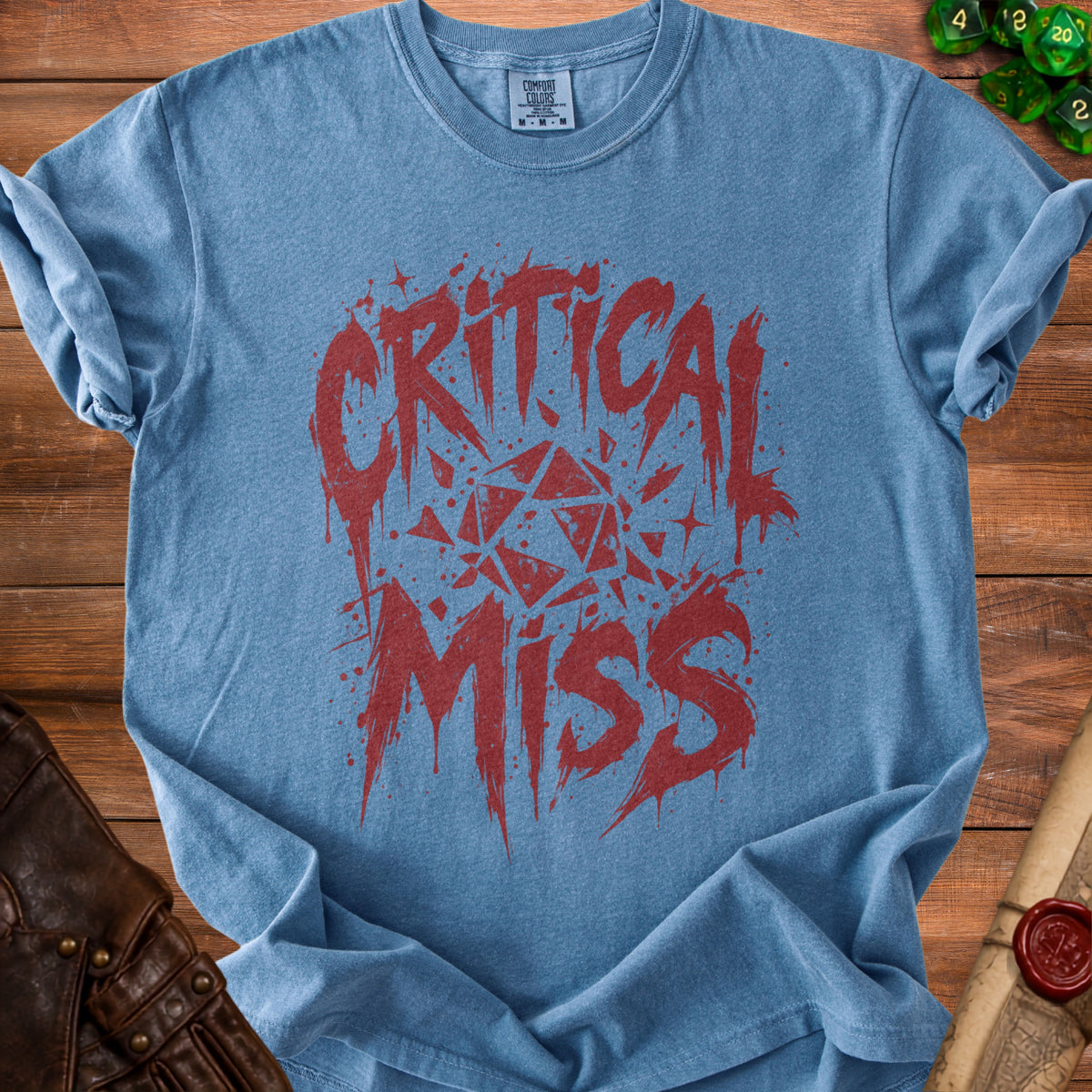 Blue t-shirt with red "Critical Miss" text and a fragmented D20 die graphic.