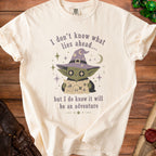 Cream t-shirt with a goblin wearing a witch hat holding a map.