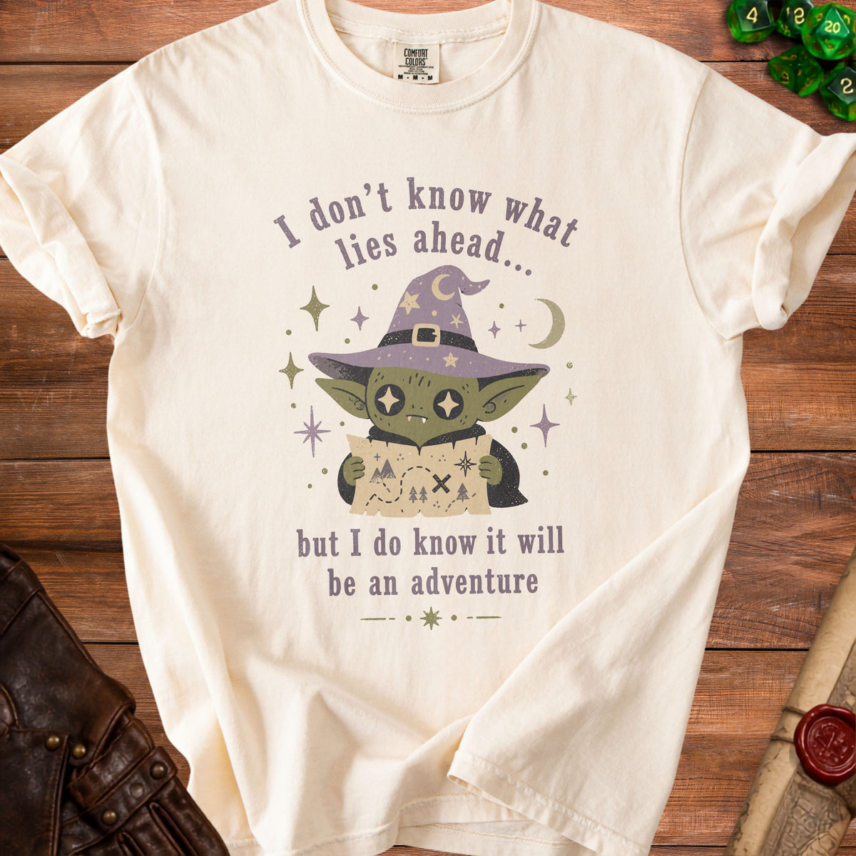 Cream t-shirt with a goblin wearing a witch hat holding a map.