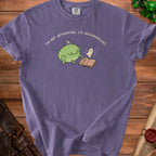 Purple t-shirt with frog in wizard hat reading spellbook to a ghost.