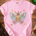 Pink t-shirt with a whimsical moth wearing a wizard hat and surrounded by stars.