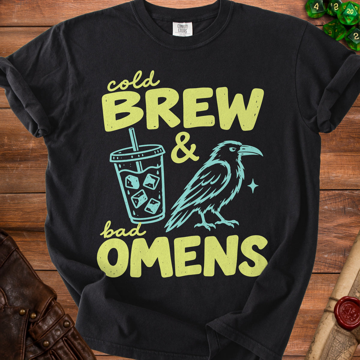Black t-shirt with "Cold Brew & Bad Omens" text, iced coffee cup, and raven graphic.