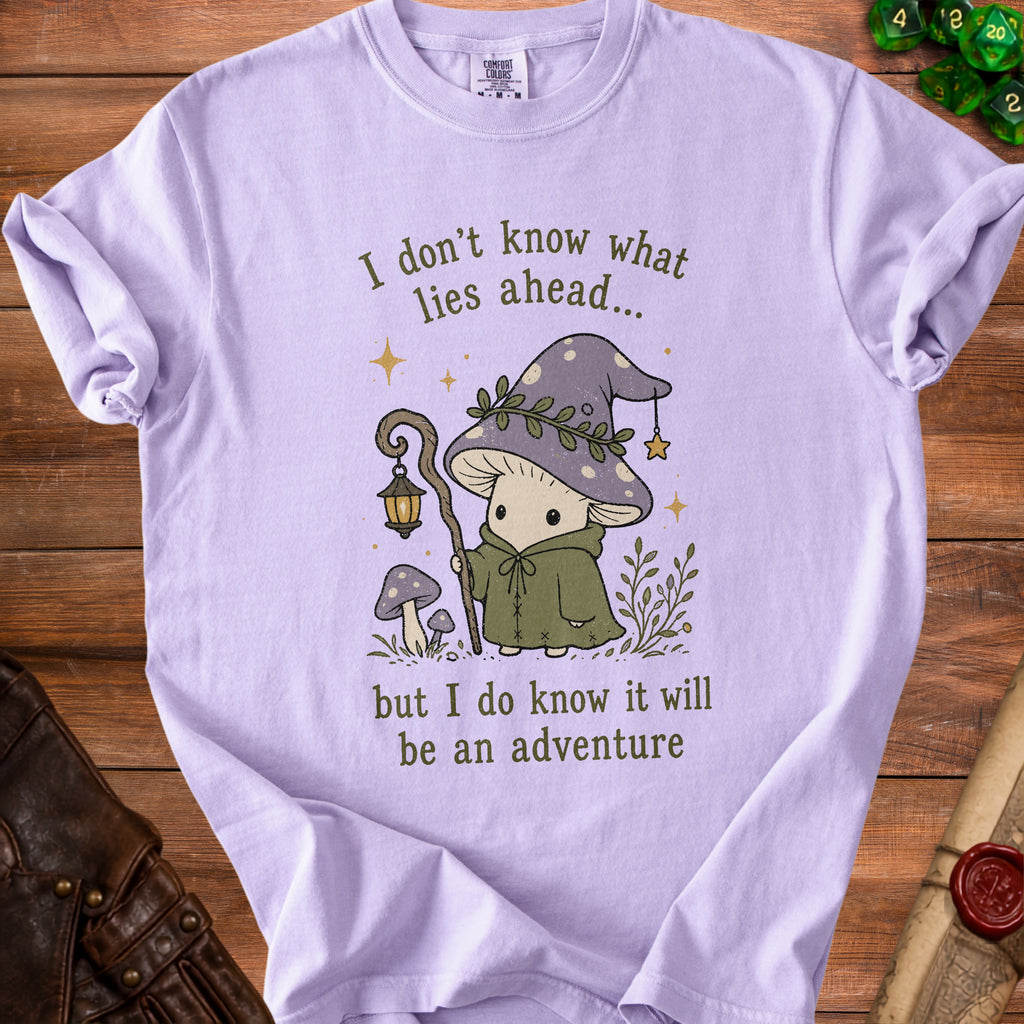 Lilac t-shirt with cartoon mushroom wizard and text about adventure.
