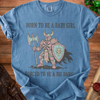 Blue shirt with knight graphic and text "BORN TO BE A BABY GIRL FORCED TO BE A BIG DAWG".