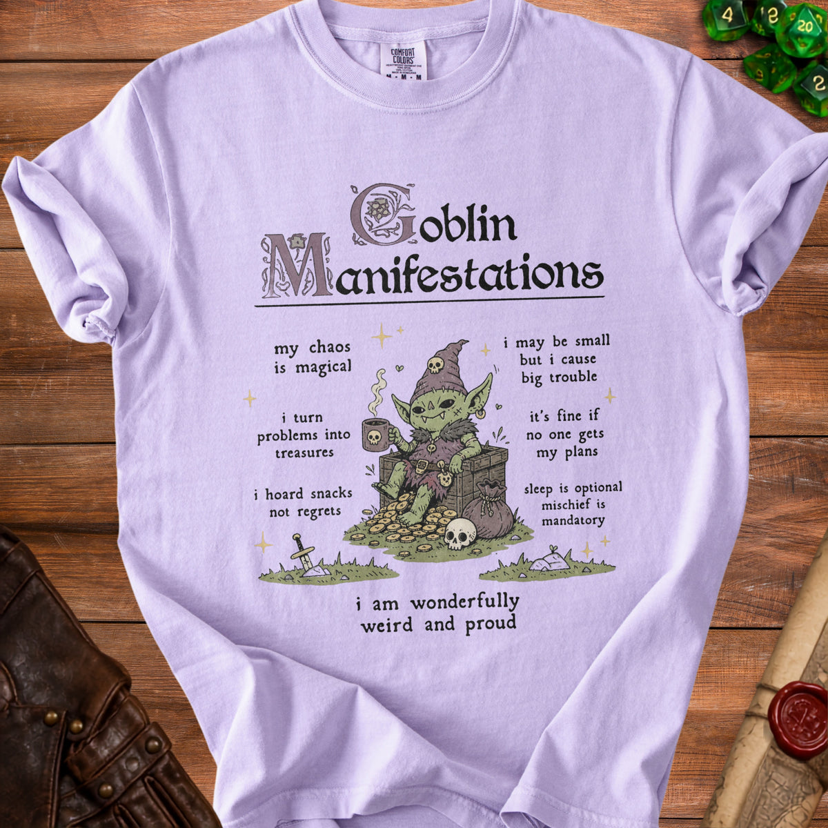 Lavender t-shirt with a goblin illustration and text "Goblin Manifestations".