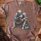 T-shirt with illustration of knight sitting with bowl and sack, text "I NEED SNACKS".
