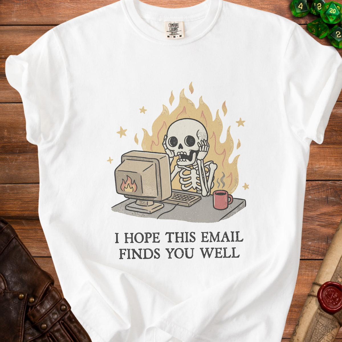White t-shirt with skeleton at computer surrounded by flames, text reads "I HOPE THIS EMAIL FINDS YOU WELL".