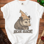 White t-shirt with a graphic of an opossum wearing a wizard hat and the text "ARCANE ADJACENT".