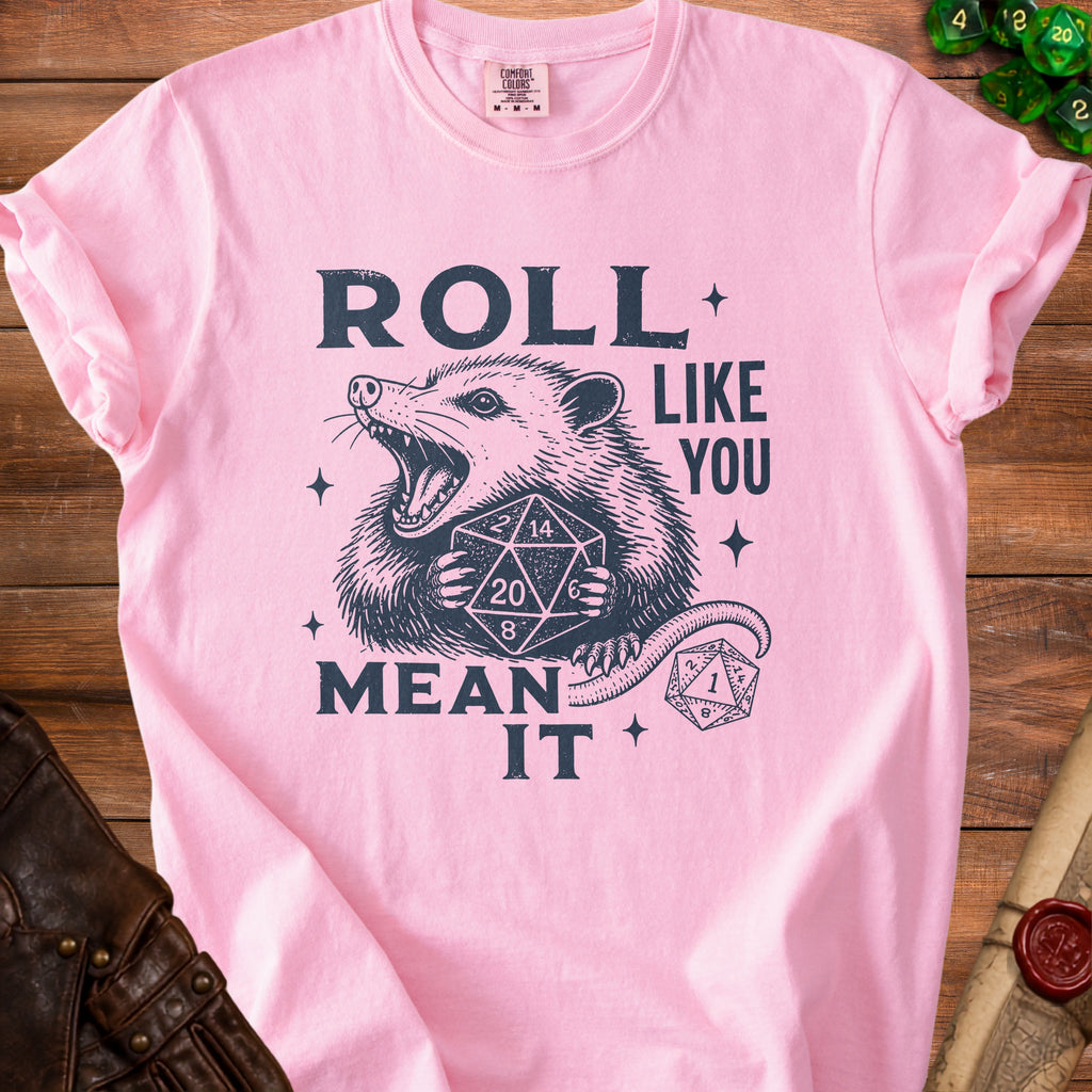 Pink t-shirt with opossum graphic and text "Roll Like You Mean It".
