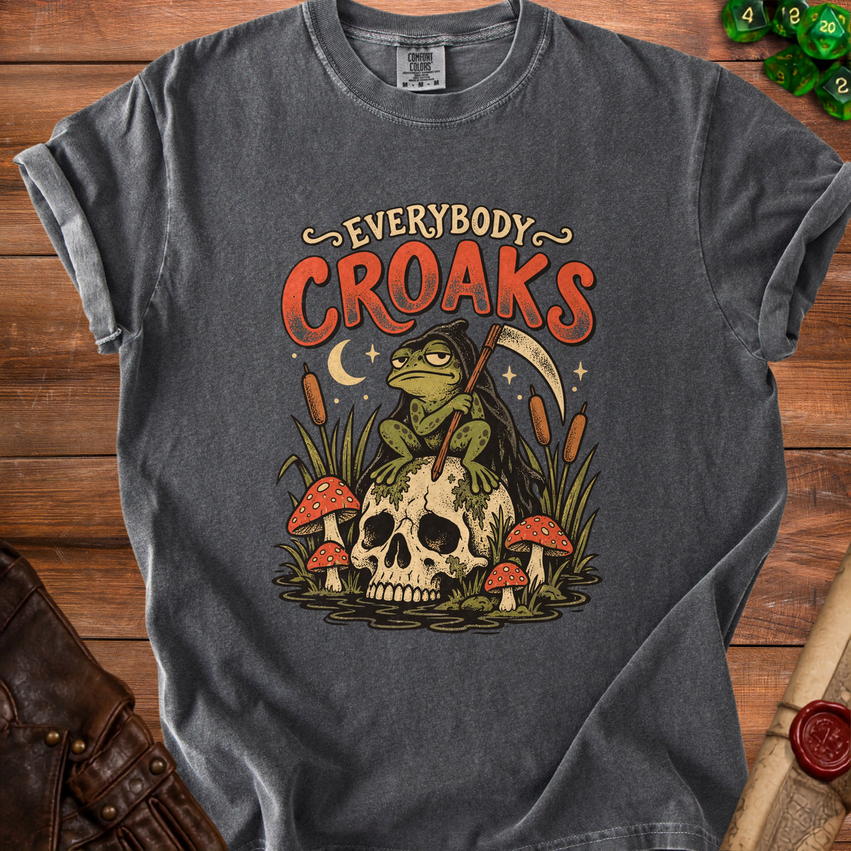 Dark grey t-shirt with "EVERYBODY CROAKS" and a grim reaper frog on a skull.