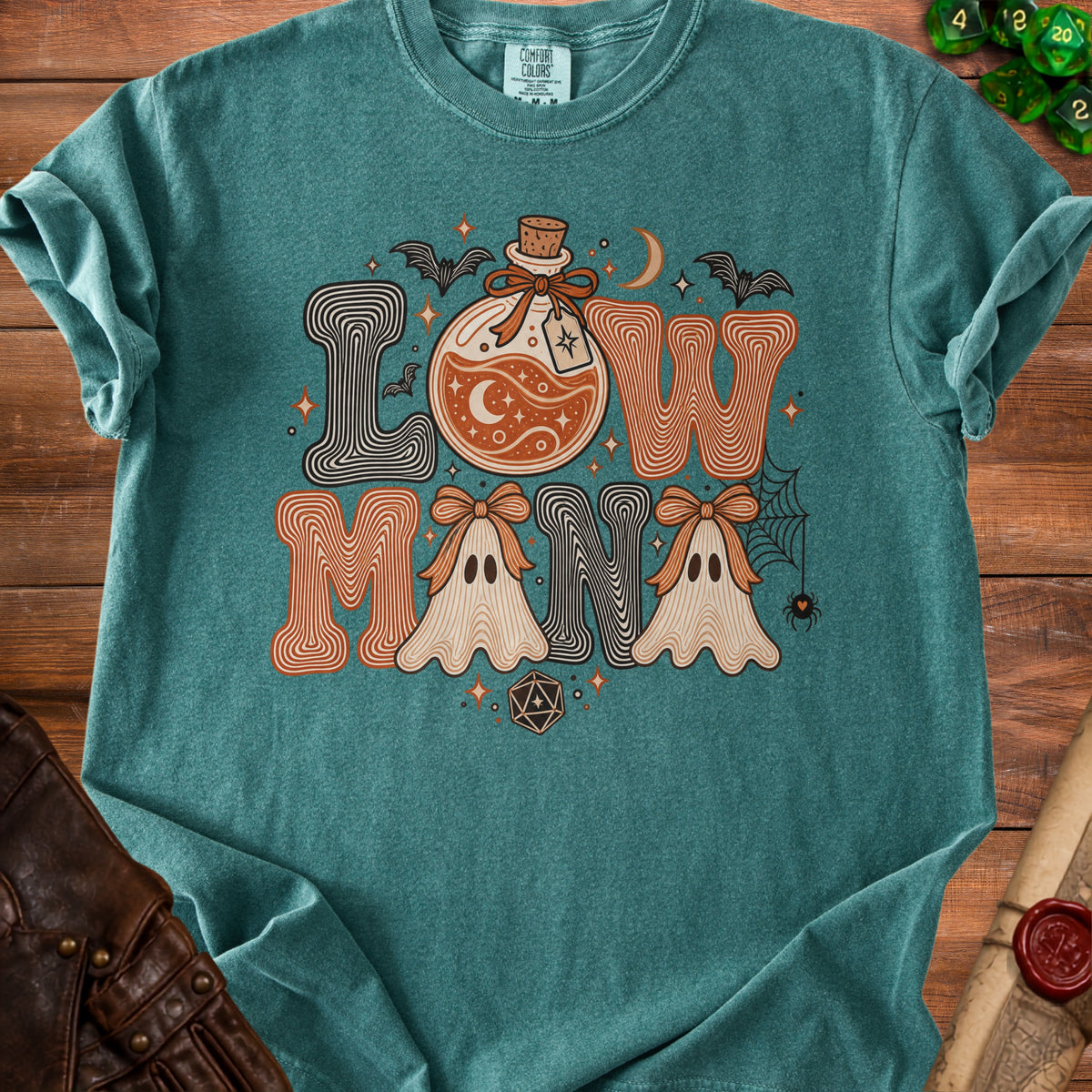 Teal t-shirt with "Low Mana" text featuring potion, ghosts, bats, moon, and dice.