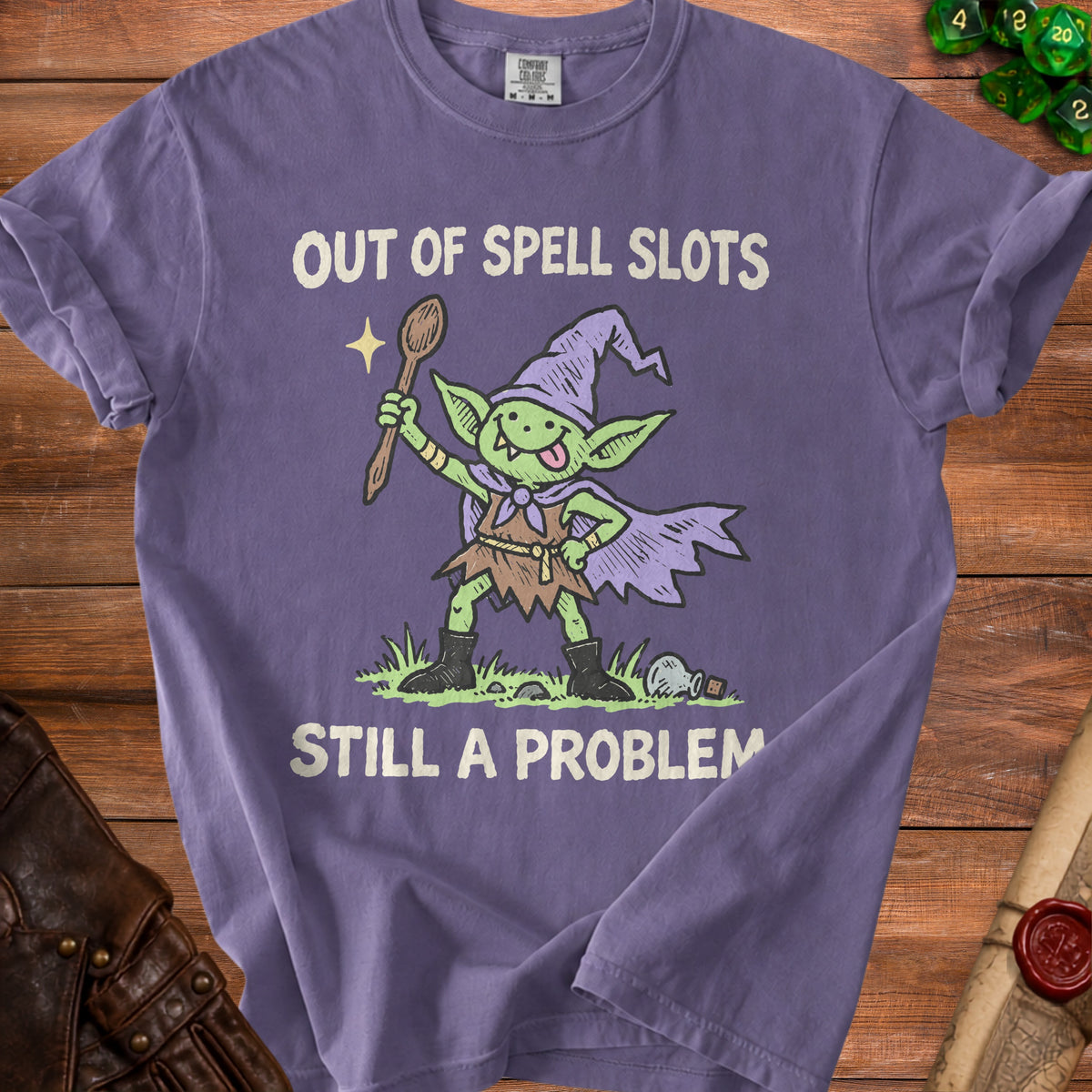 Purple t-shirt with goblin wizard graphic and text "Out of Spell Slots Still a Problem."