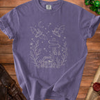 Purple t-shirt with white line art of bats, chest, mushrooms, and signpost.